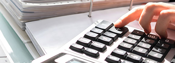 a person using a scientific calculator for accounting